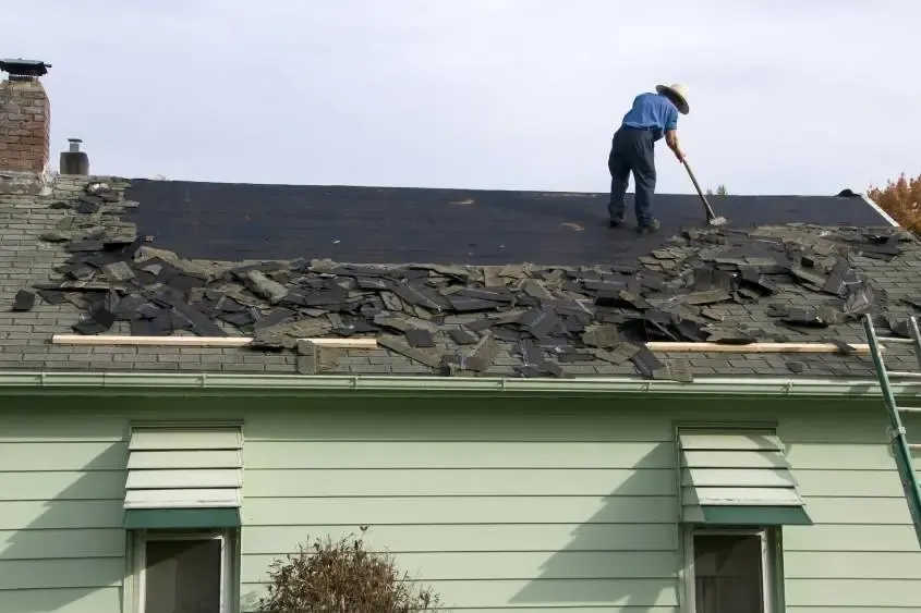 A contractor prepares a roof for a replacement