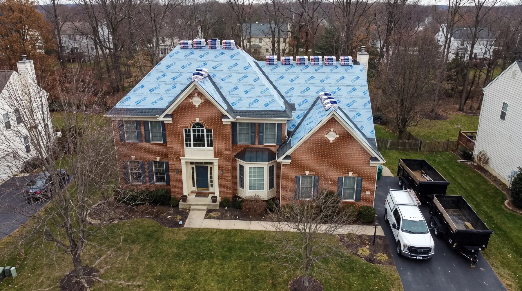 Drone aerial of a large brick colonial home in Northern Virginia, freshly installed architectural shingle roof, completed LCR Exteriors job