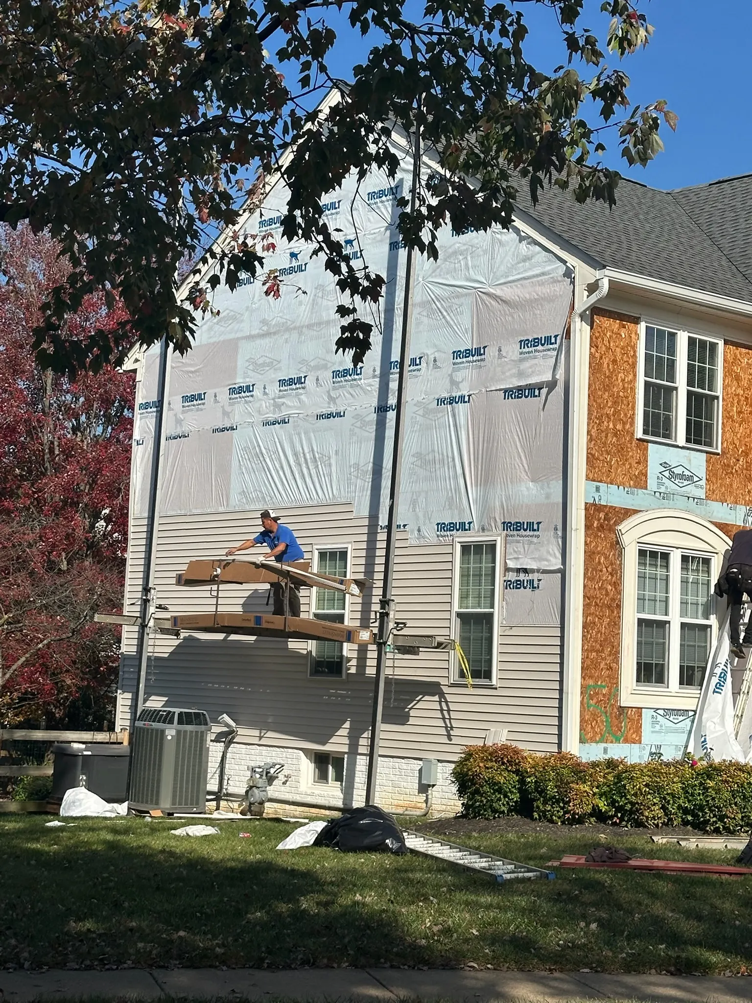 LCR siding replacement in progress on a Northern Virginia townhouse, house wrap installed over new sheathing