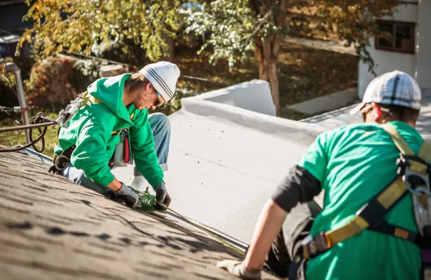 Professional roofers do measurements on the roof